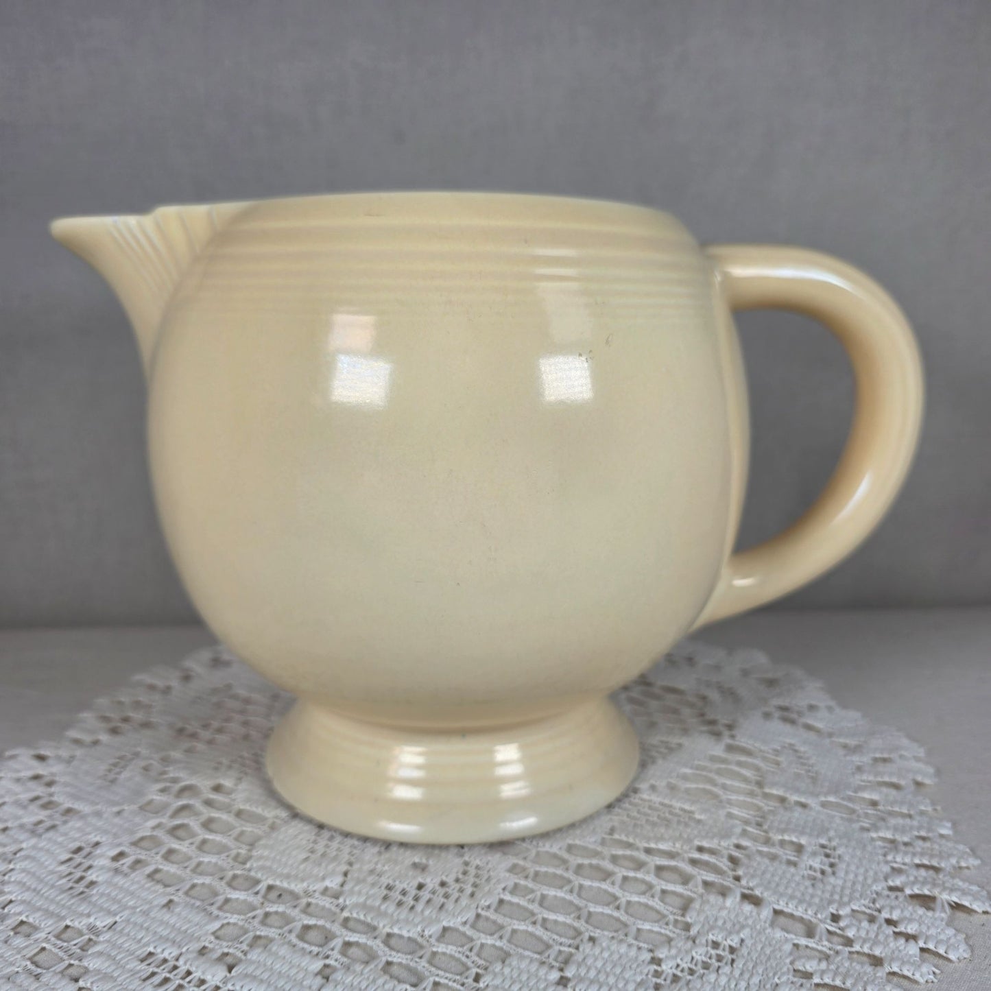 Vintage Fiesta Ivory Ice Lip Pitcher 9 1/2" Wide 7" Tall With Minor Chips On Base Edge
